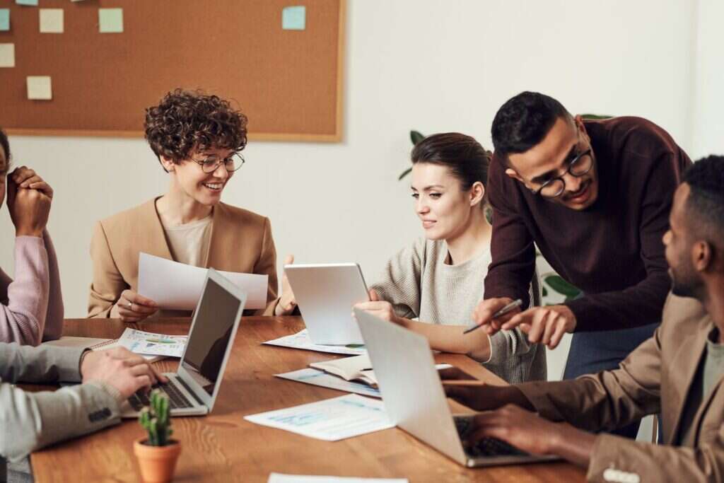 Colleagues in a small business consultation around a laptop