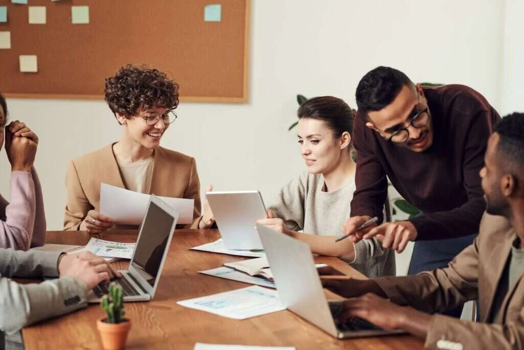 Colleagues in a small business consultation around a laptop