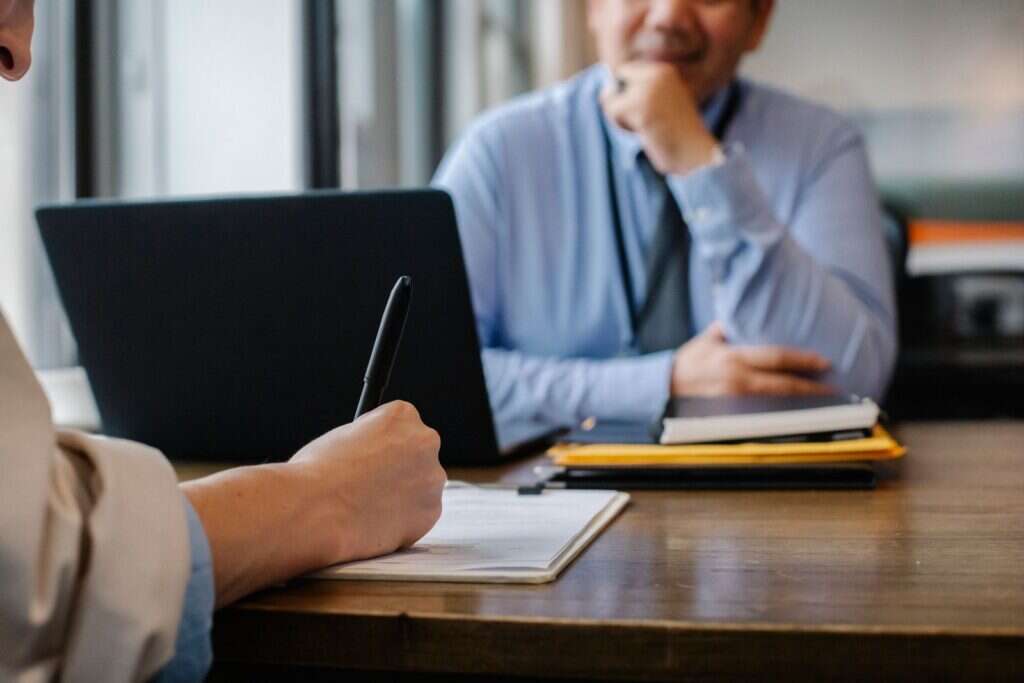 Client and advisor reviewing tax documents together at a desk